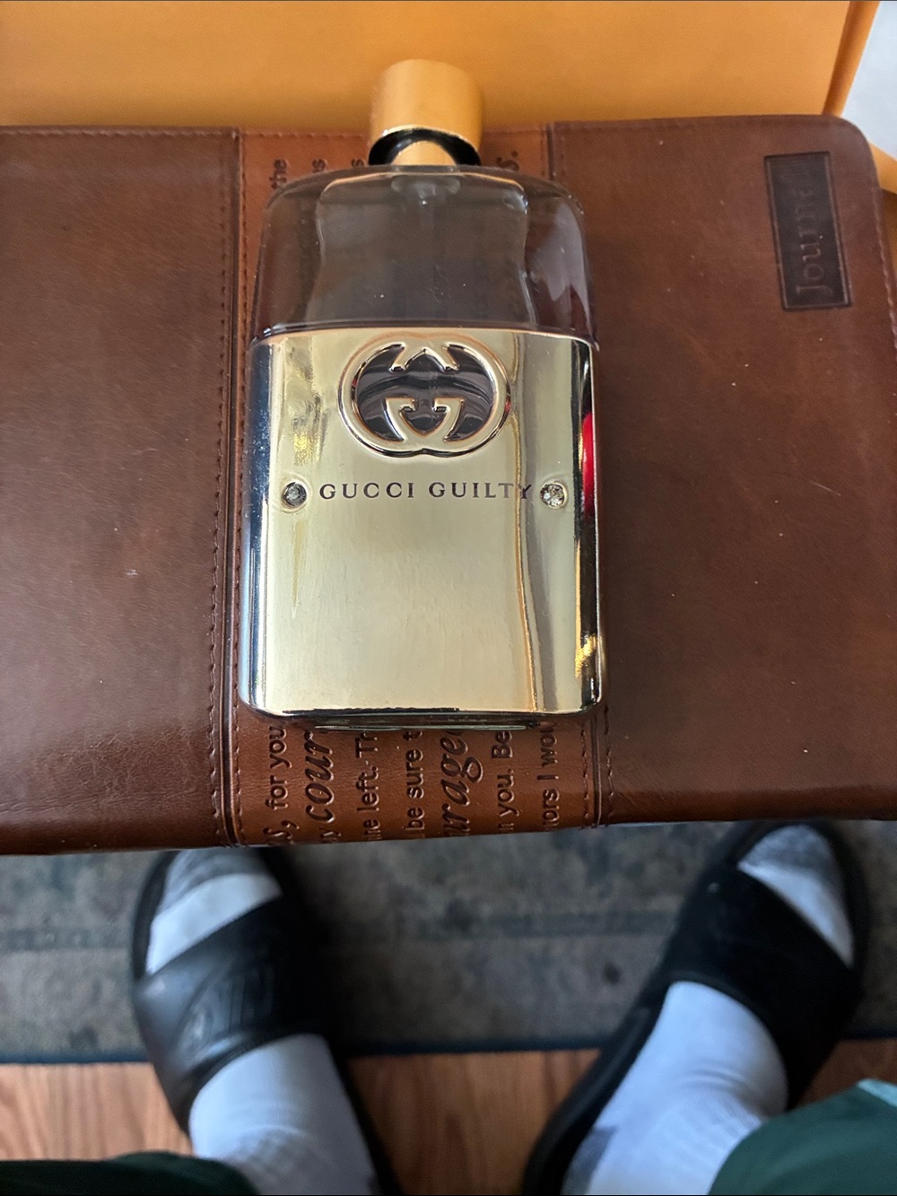 Gucci silver bottle with dark blue liquid refillable scent